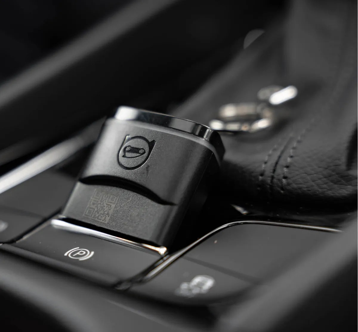 OBDeleven V3 device plugged in beside the gear selector of a VW
